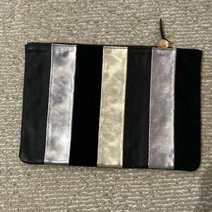 Leather clutch from Clare V. with 3 stripes(1 gold and 2 silver surrounding.)